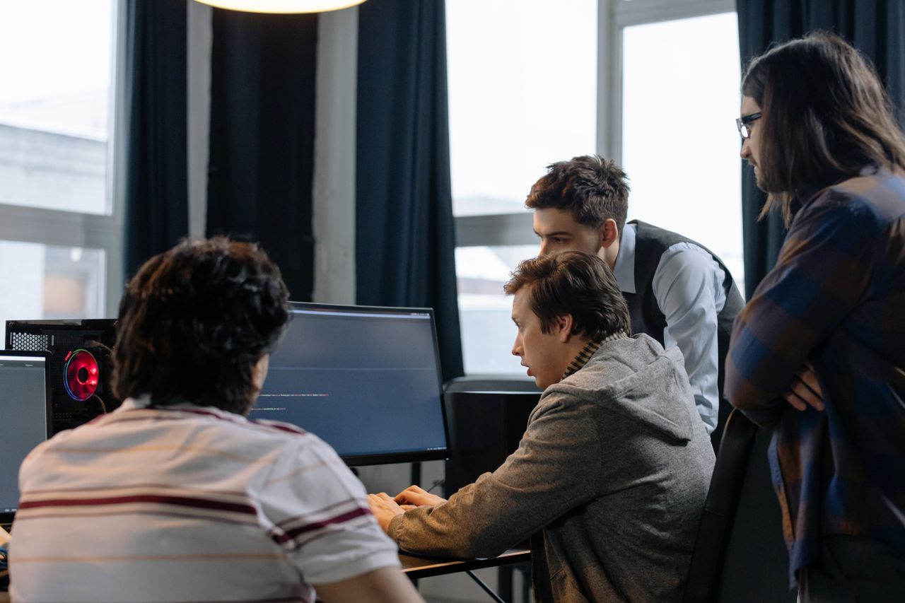 The Art of Drawing Readers In: Your attractive post title goes here Group of developers working together on a computer programming project indoors.